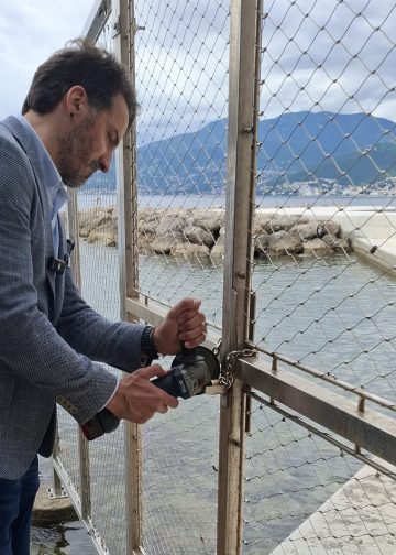 Marin Miletić brusilicom reže lokot na prolazu uz plažu kod Hiltona u Rijeci